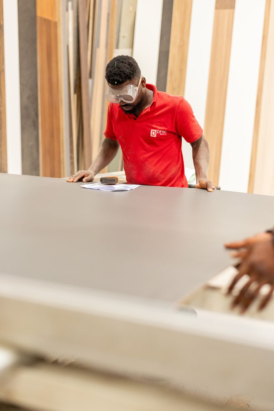 Technician checking a board in front of decor samples